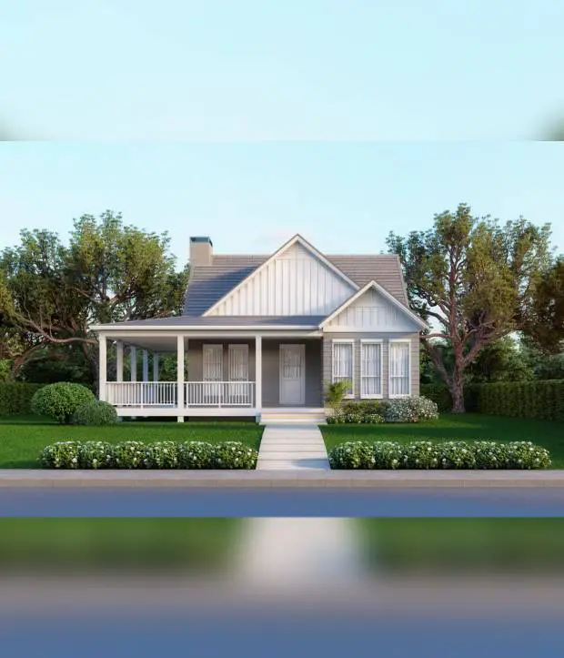 A charming white house with a spacious porch and lush greenery.