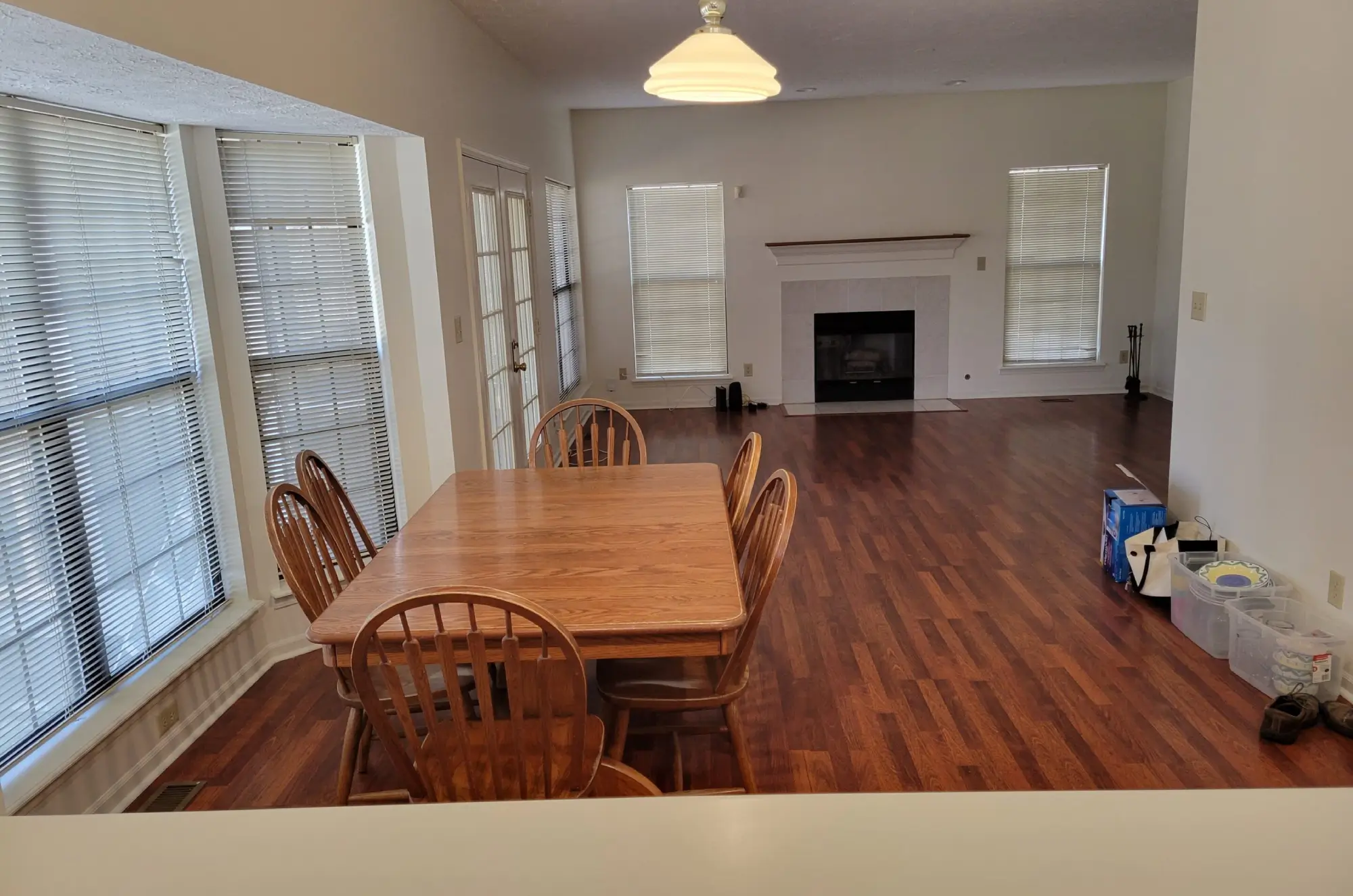 Spacious dining room with wooden table and chairs near fireplace.